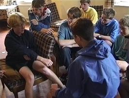Llewellyn prepares his hand to be punished by Luke's pack of cards in Kings youth hostel Common Room - all part of the game apparently